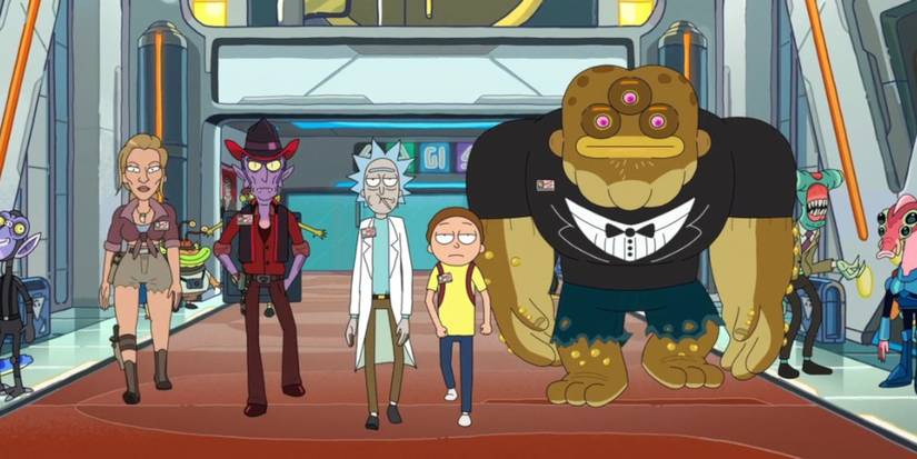 Rick and Morty walk down a hallway with other aliens in Rick and Morty.