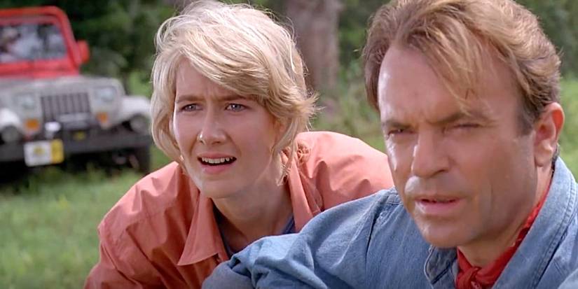 Dr. Ellie Sattler (Laura Dern) and Dr. Alan Grant (Sam Neill) looks on in awe at the dinosaurs in Jurassic Park.