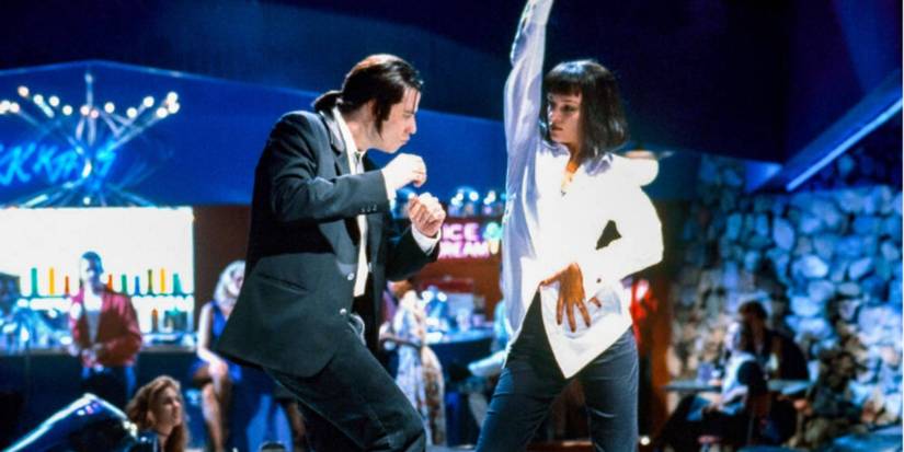 John Travolta and Uma Thurman as Vincent Vega and Mia Wallace wearing a black suit and white shirt dancing in a diner in 'Pulp Fiction'