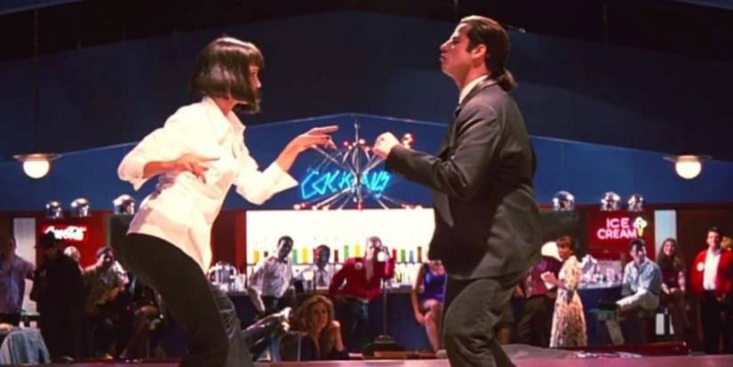 Uma Thurman and John Travolta as Mia Wallace and Vincent Vega dancing in a white shirt and black suit in 'Pulp Fiction'.