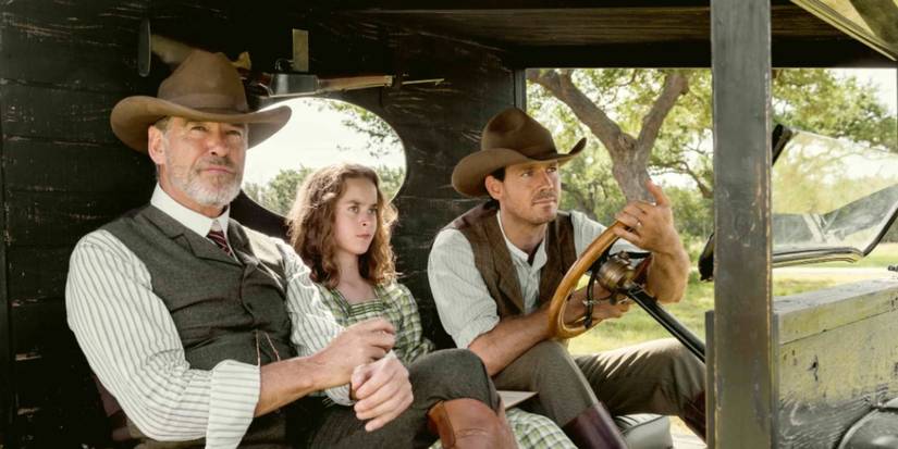 Pierce Brosnan, Sydney Lucas, and Henry Garrett as Eli, Jeanie, and Pete McCullough sitting in a car outside in 'The Son.'