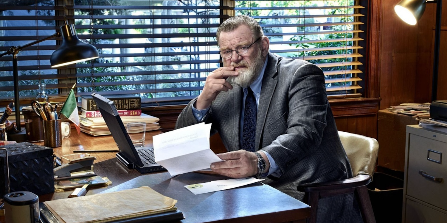 Brendan Gleeson going through paperwork at his desk in Mr. Mercedes