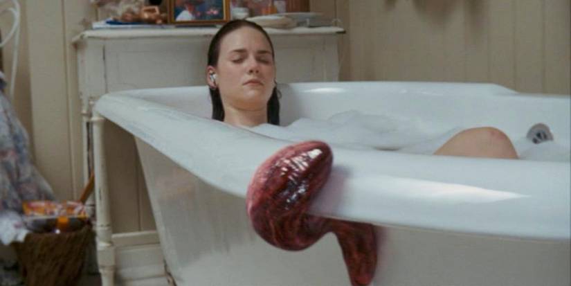 A red alien parasite crawling into a bathtub in Slither (2006), directed by James Gunn