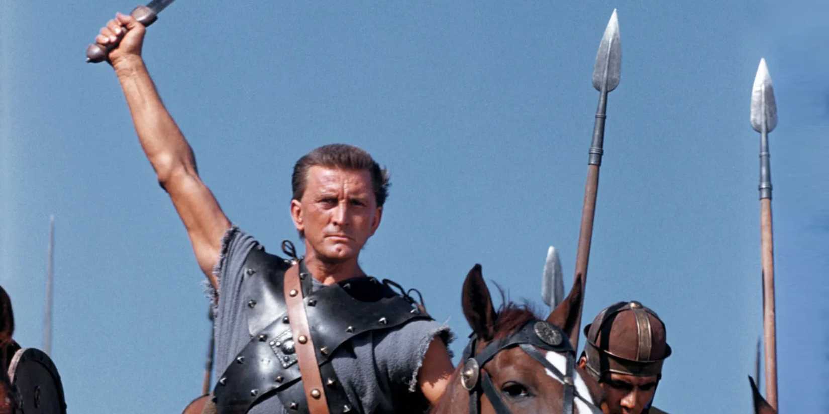 Kirk Douglas holding up a sword and preparing to go into battle in Spartacus (1960)