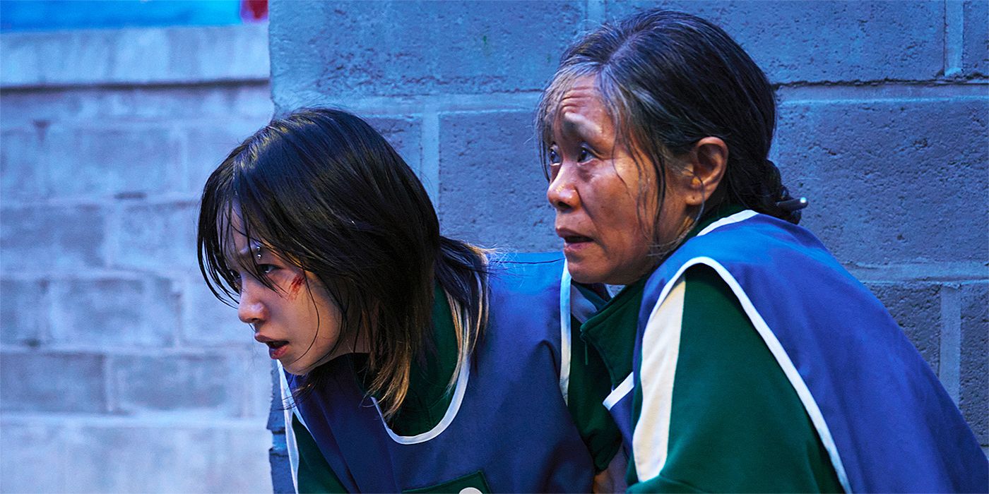Geum-ja (Kang Ae-shim) holding Jun-hee (Jo Yu-ri), who's in labor, in Squid Game Season 3.