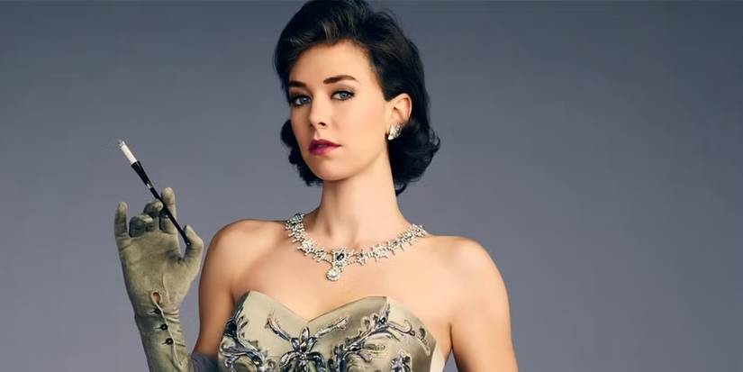 Vanessa Kirby as Princess Margaret, sporting a dress and holding a paintbrush between the fingers of her raised left hand, in a promotional image from 'The Crown.'