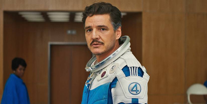 Pedro Pascal as Reed Richards in a spacesuit at a press conference in The Fantastic Four: First Steps.