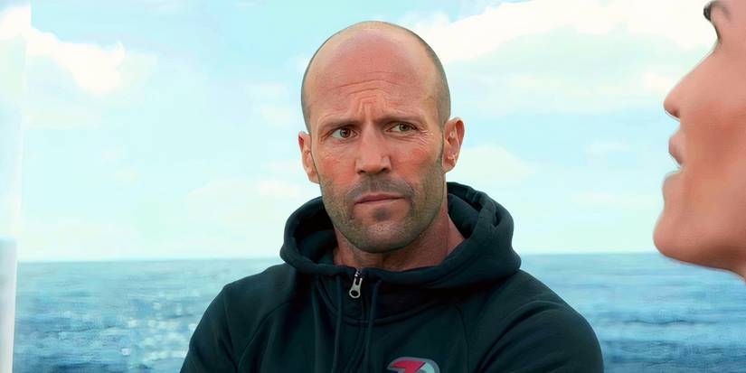 Jason Statham as Jonas Taylor on a boat looking at someone who's talking in The Meg