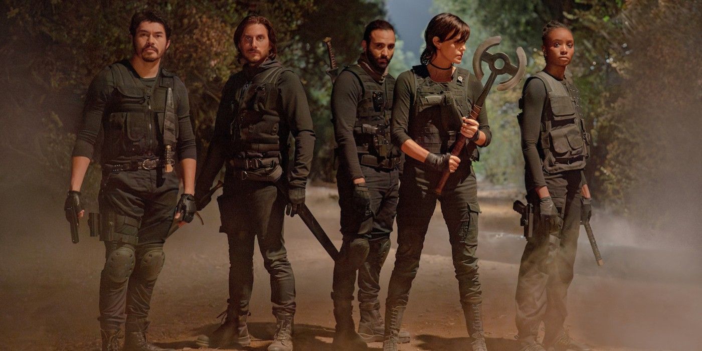 The cast of 'The Old Guard 2' posing with their weapons