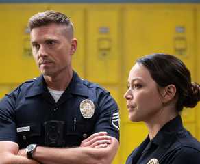 The Rookie's Eric Winter & Melissa O'Neil stand in uniform