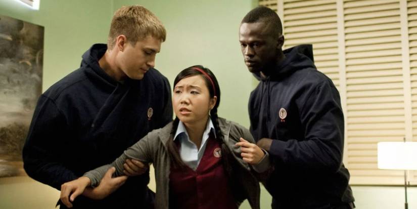 Dyana Liu as Suki getting manhandled by two guards in Tower Prep.