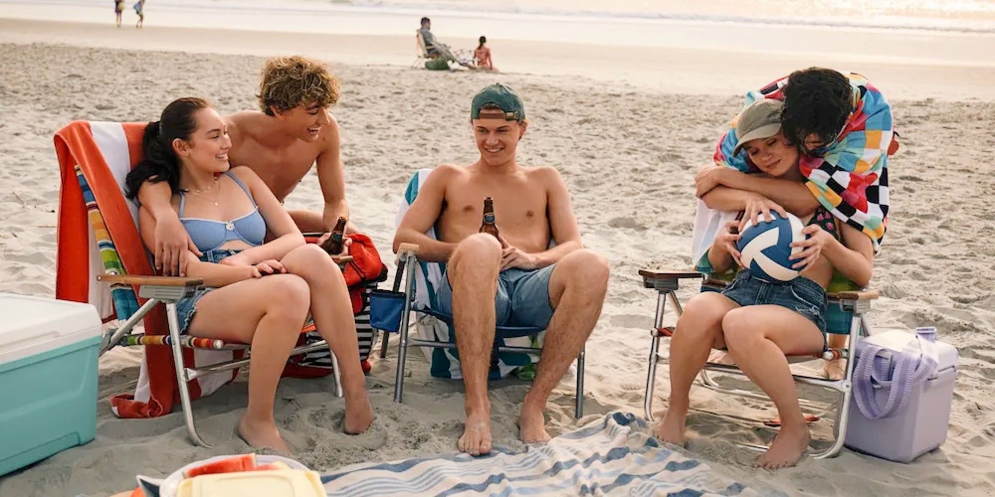Belly Conklin, Jeremiah Fisher, Conrad Fisher, Taylor Jewell, and Steven Conklin sitting at the beach together in The Summer I Turned Pretty TSITP Season 3