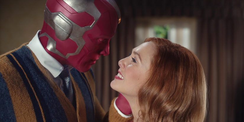 Paul Bettany as Vision looking at Elizabeth Olsen as Wanda, who is smiling, in Wandavision.