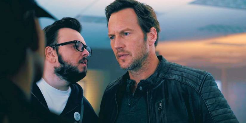 John Bradley talking into Patrick Wilson's ear in Moonfall