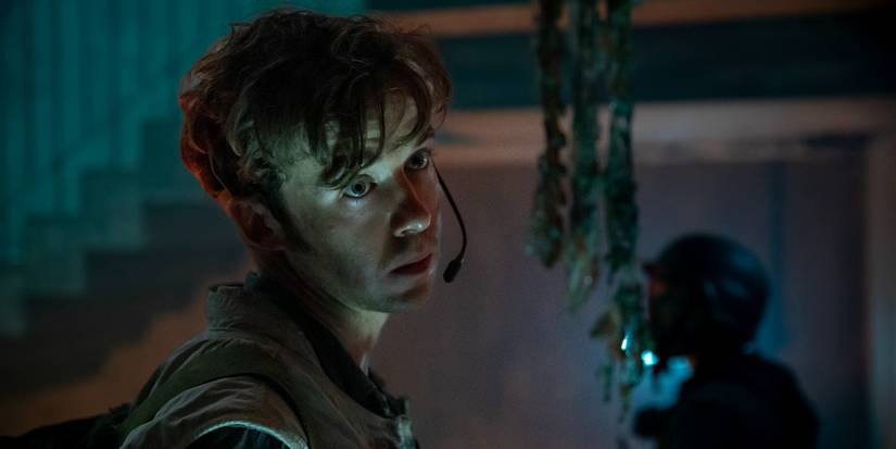 Alex Lawther as Hermit/Joe wearing a headset and looking to the side in Alien: Earth.