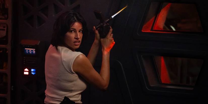 Zaveri (Richa Moorjani) holding a small blowtorch and looking to the side in Alien: Earth.