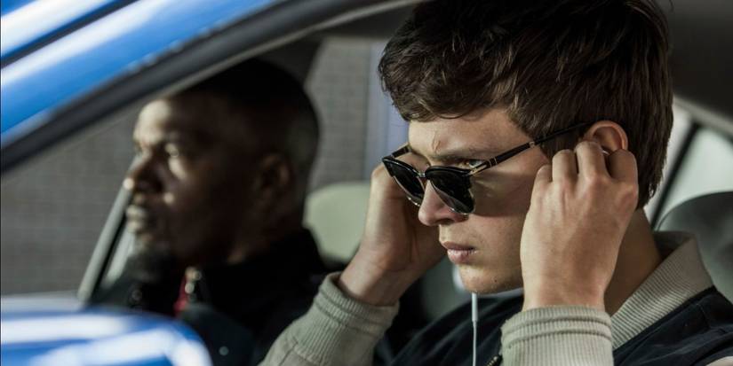 Ansel Elgort and Jamie Foxx sit in a car, while Elgort puts in wired ear-buds in Edgar Wright's 'Baby Driver'