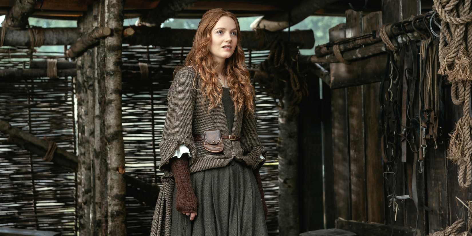Harriet Slater as Ellen MacKenzie standing outside looking off to the left in Outlander: Blood of My Blood