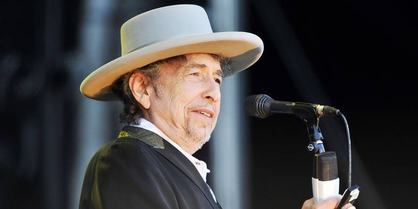 Bob Dylan onstage in front of a microphone.