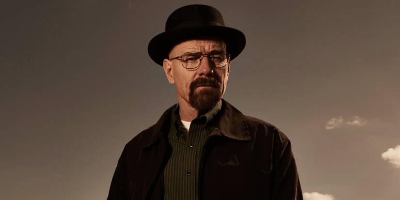 Bryan Cranston as Walter White standing in the desert and scowling in a promotional image for Breaking Bad.
