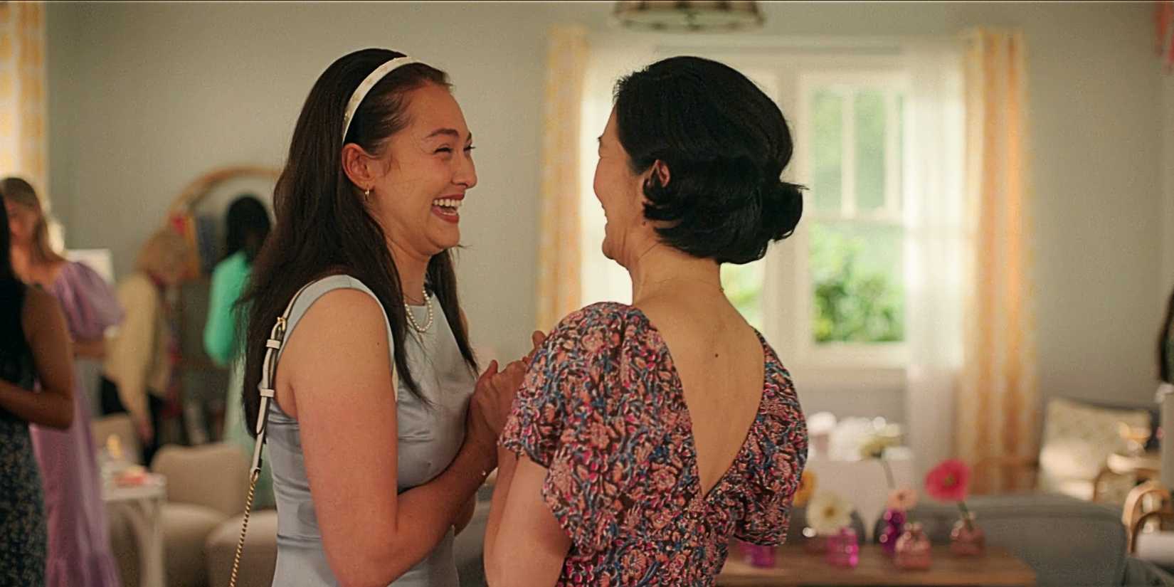 Belly Conklin and Laurel Park laughing and holding hands in The Summer I Turned Pretty TSITP Season 3