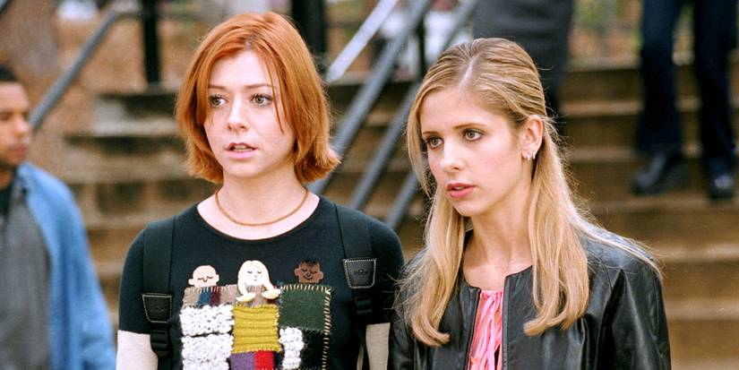 Sarah Michelle Gellar and Alyson Hannigan look serious in front of steps in Buffy the Vampire Slayer.