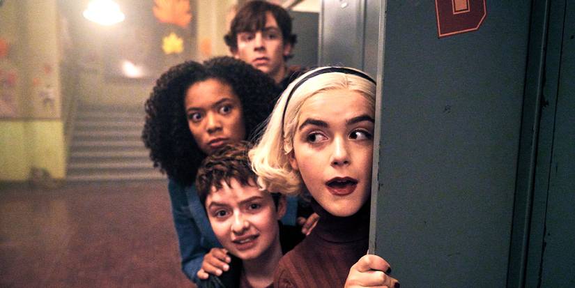 The cast peer around the door of a locker in a school hallway in Chilling Adventures of Sabrina.