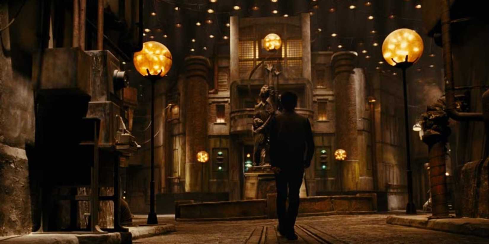 A man standing in the middle of an underground dystopian city in City of Ember