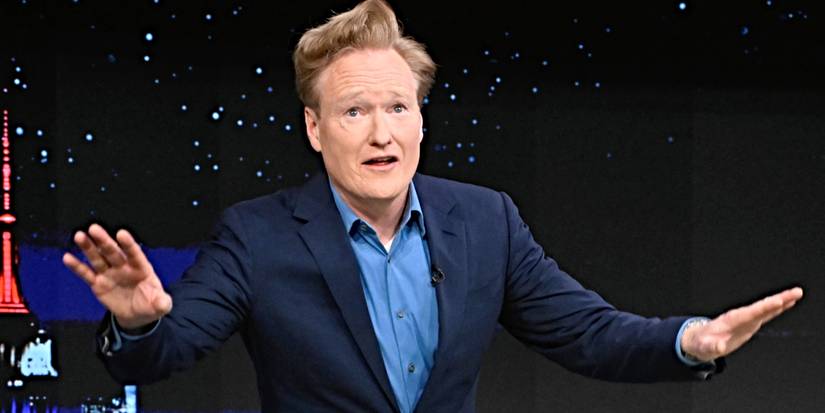Conan O'Brien holding his arms outward while hosting The Tonight Show