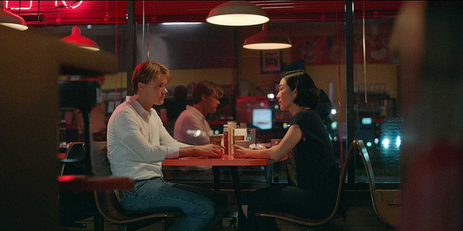 Conrad Fisher and Laurel Park sitting at a diner together in The Summer I Turned Pretty TSITP Season 3