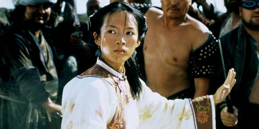 A woman in a martial arts stance in a crowd looking resolute in Crouching Tiger, Hidden Dragon. 
