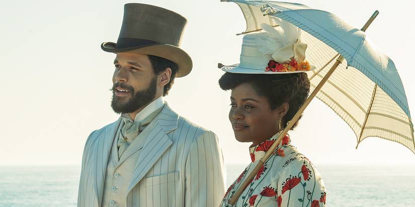 Denée Benton as Peggy walking with a parasol next to Jordan Donica as William in The Gilded Age Season 3.