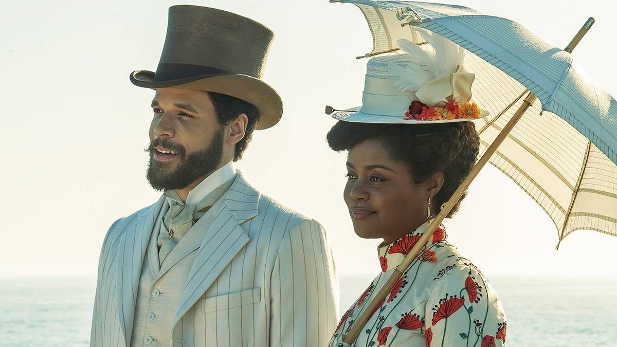 Denée Benton as Peggy walking with a parasol next to Jordan Donica as William in The Gilded Age Season 3