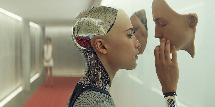 Ava looking at human faces on a wall in Ex-Machina