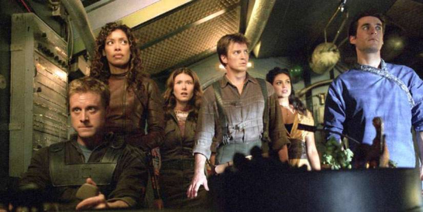 Nathan Fillion, Alan Tudyk, Gina Torres, and more cast of Fox's Firefly look concerned in a ship.