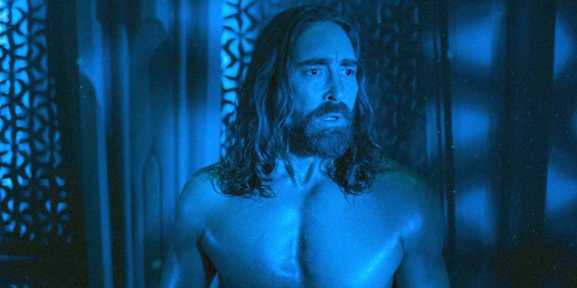 Day, shirtless, standing in blue-tinted darkness in Foundation Season 3 Episode 7