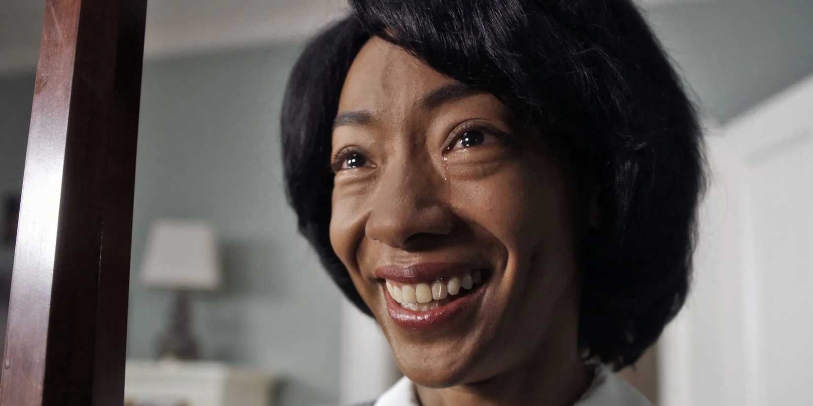 A Black woman smiling while crying in Get Out (2017)