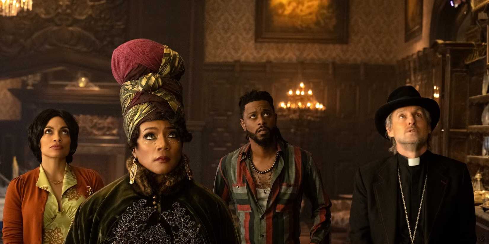 Rosario Dawson, Tiffany Haddish, LaKeith Stanfield, and Owen Wilson look up in Haunted Mansion.