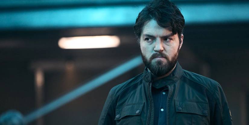Tom Burke as Rebrov scowling in The Lazarus Project.