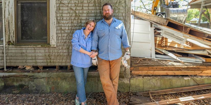 Erin and Ben Napier pose in front of a home during demo on 'Home Town.'