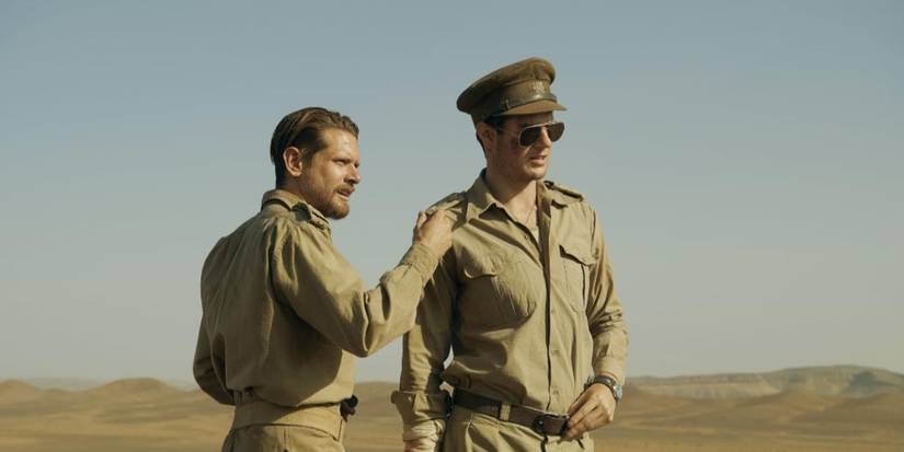 Jack O'Connell and Connor Swindells stand in the desert in SAS Rogue Heroes