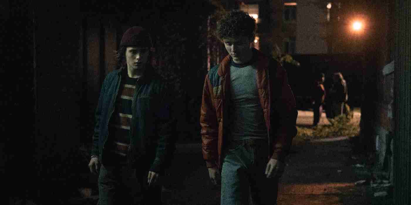Two young men walk down the street at night in Devil in Disguise: John Wayne Gacy