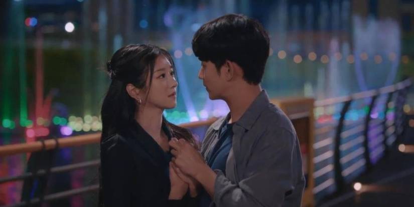 Kim Soo-hyun and Seo Ye-ji hold hands and look at each other on a bridge at night in It's Okay to Not Be Okay.