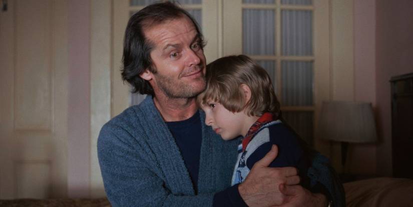 Jack holds a frightened Danny in his lap in The Shining