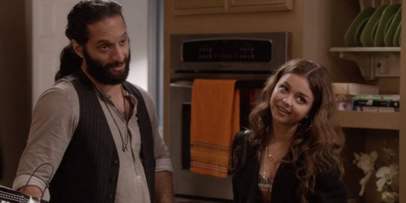 Jason Mantzoukas and Sarah Hyland smiling in "Party Crasher" in 'Modern Family'