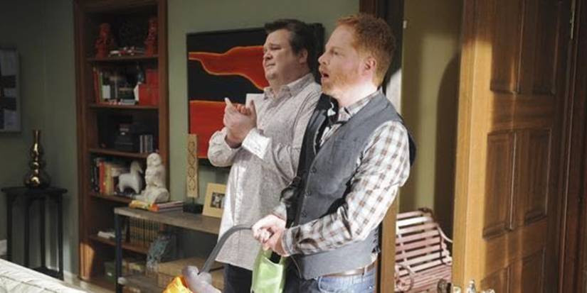 Jesse Tyler Fersuon and Eric Stonestreet looking at someone in "Not in My House" in 'Modern Family'