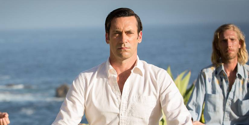 Jon Hamm as Don Draper sitting at a beach retreat in the series finale of Mad Men.