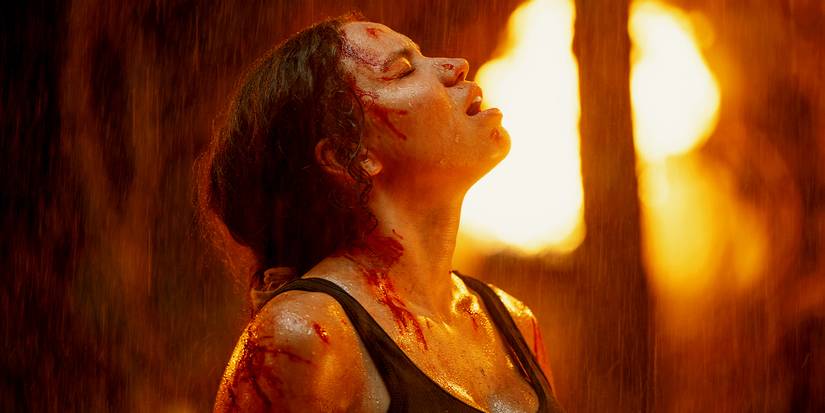 Jurnee Smollet under the rain in a burning forest in Smoke