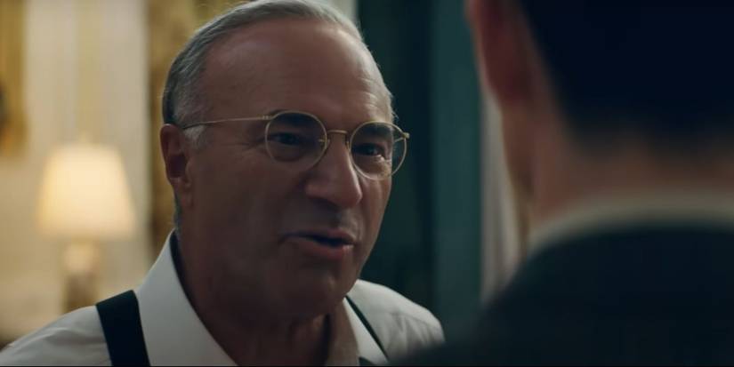 Kevin O’Leary talking sternly to someone off camera in Marty Supreme