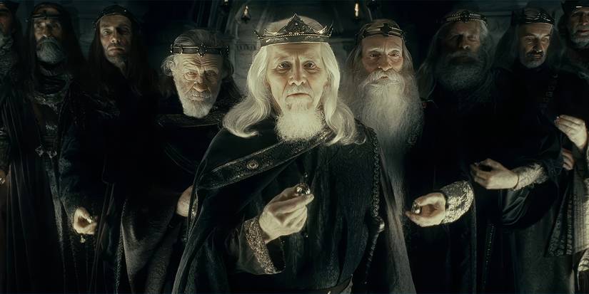 Eight cloaked men, standing in a chevron arrangement, each holding a gold ring in Lord of the Rings: The Fellowship of the Ring.